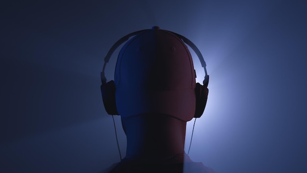 Un homme avec des écouteurs dans les faisceaux d'un projecteur Vue arrière