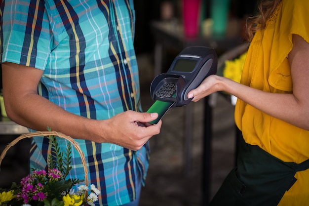 Homme effectuant le paiement avec sa carte de crédit