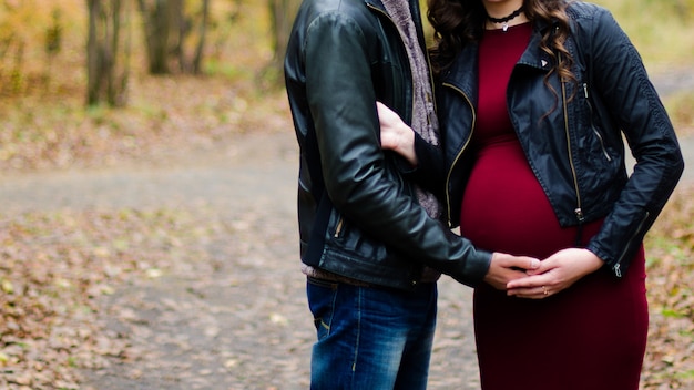 Homme embrassant une femme enceinte dans les bois d&#39;automne,