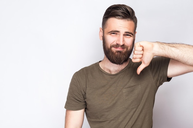 Homme émotif en tshirt vert sur fond gris