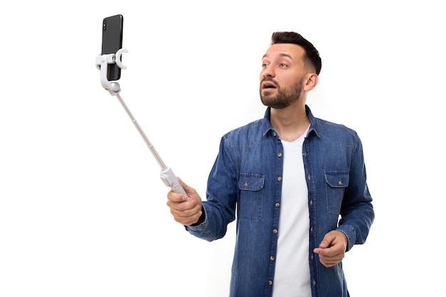 Un homme enregistre une vidéo avec une perche à selfie
