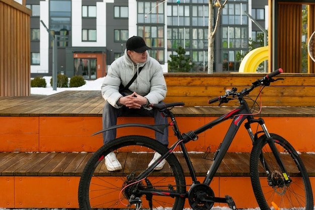 Un homme européen assis et se reposant entre deux manèges à vélo