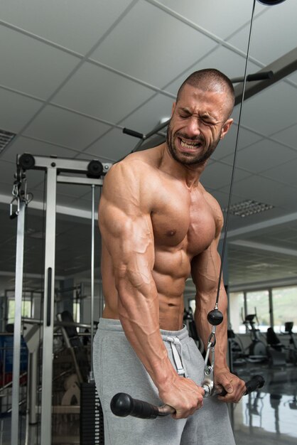 Homme exerçant des triceps dans la salle de gym