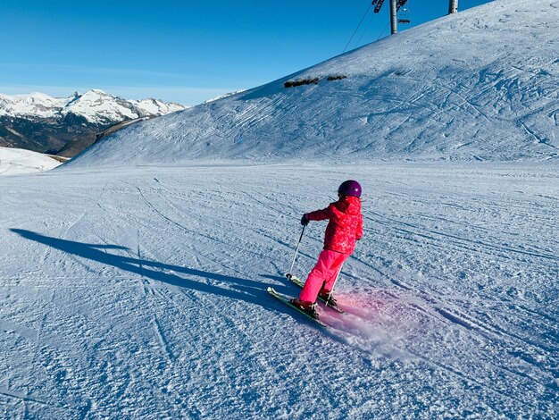 Un homme faisant du ski sur une montagne enneigée en hiver