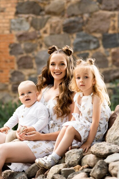 Un homme et une femme heureux jouent avec des enfants à l'extérieur par une journée ensoleillée