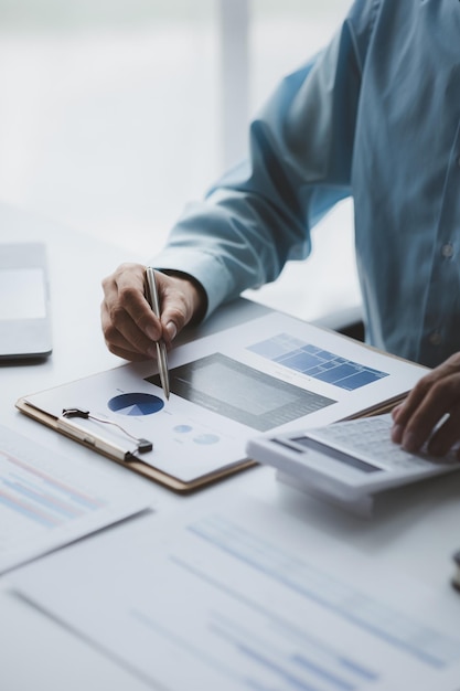 Un homme de la finance d'entreprise examine les documents financiers d'une entreprise préparés par le Département des finances pour une réunion avec des partenaires commerciaux Concept de validation de l'exactitude des chiffres financiers