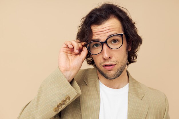 Homme gai en costume posant des émotions porter des lunettes fond beige