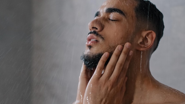 Homme indien arabe barbu homme nu se lave la tête avec du shampoing, lave les cheveux, le visage et la barbe