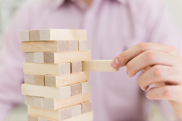 Homme jouant avec des blocs de bois