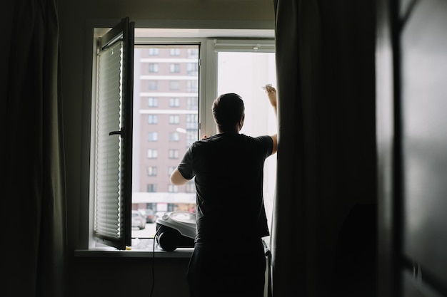 Homme lavant et nettoyant la fenêtre à la maison Travaux ménagers et entretien ménager hygiène domestique