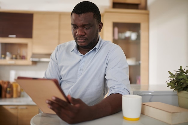 Homme lisant un ebook sur une tablette