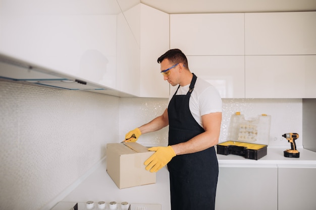 Un homme de maintenance ouvre la boîte avec de l'équipement de plomberie