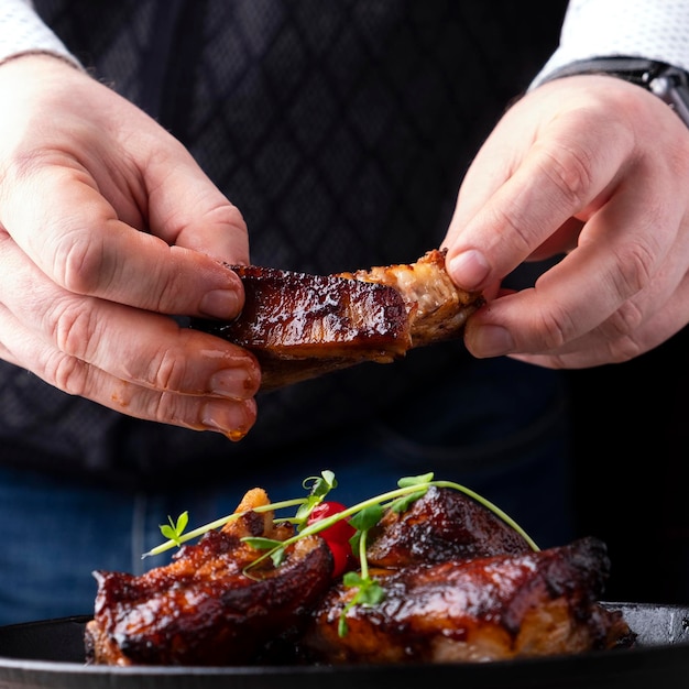 Homme mangeant des côtes levées de porc barbecue