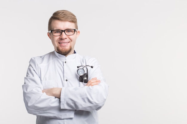 Homme médecin souriant avec stéthoscope sur fond blanc avec espace de copie