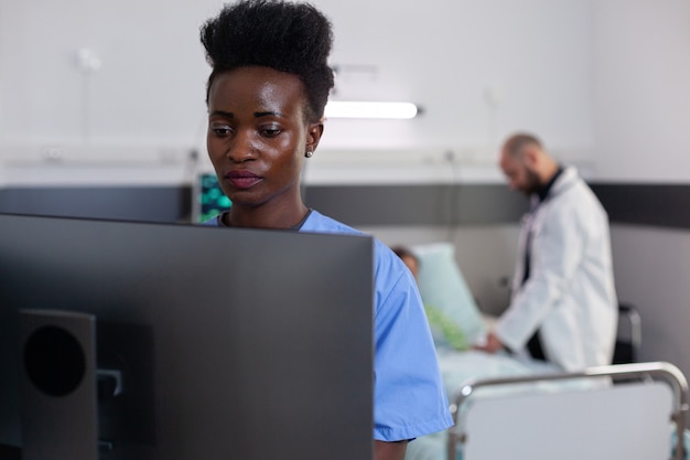 Un homme médecin vérifiant une patiente malade lors d'un rendez-vous médical à l'hôpital un médecin discute...