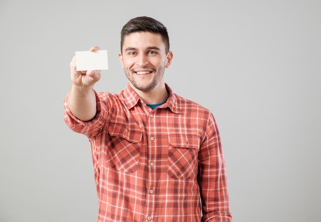 Un homme montrant une carte de visite blanche.