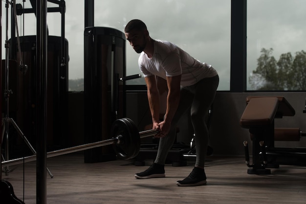 Homme musclé faisant de l'exercice avec des haltères