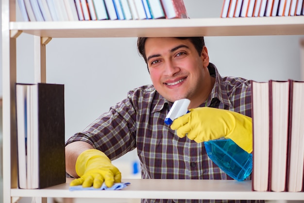 Photo homme, nettoyage, poussière, de, bibliothèque