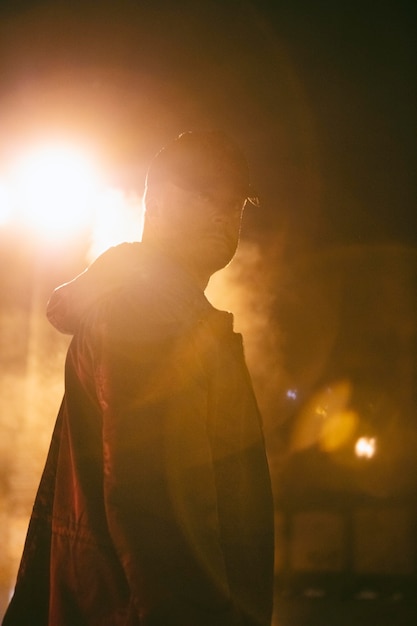 Photo homme la nuit dans la ville avec de la fumée