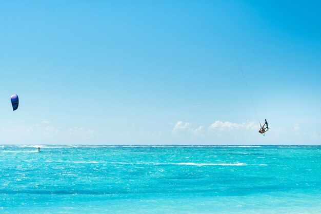 Un homme en parapente sur la plage du Morne, Maurice, océan Indien sur l'île Maurice.