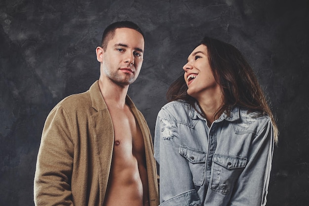 L'homme pensif pose pour le photographe avec sa petite amie souriante au studio photo.