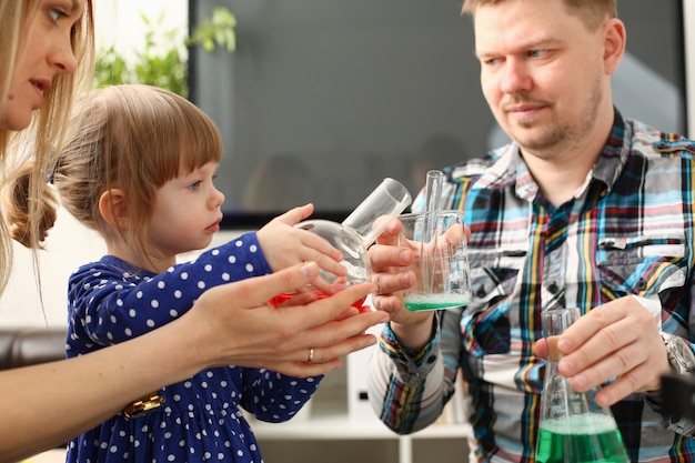 L'homme et la petite fille jouent avec des liquides colorés