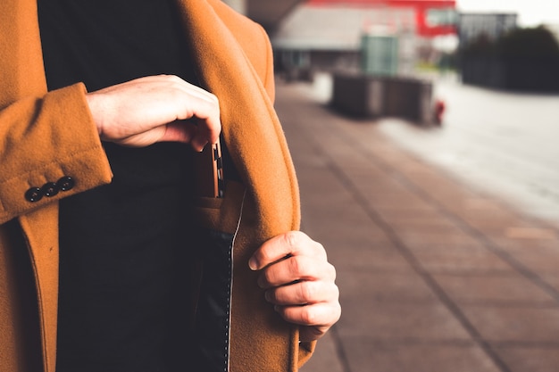 Homme Prenant Un Portefeuille De La Poche Intérieure De Son Manteau