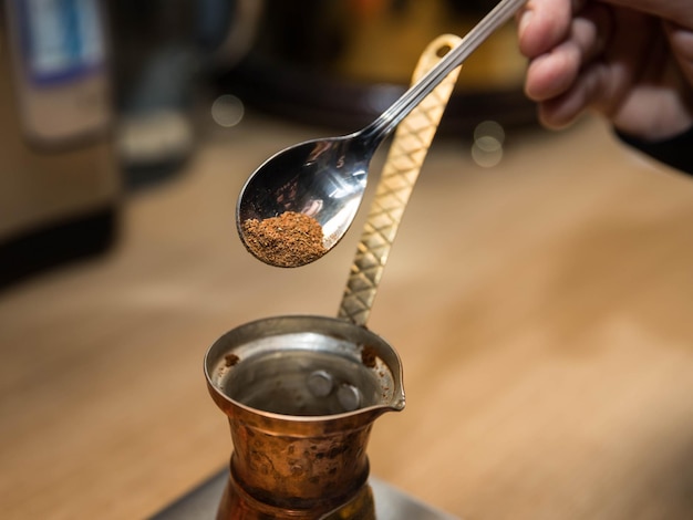 Un homme prépare du café Café turc cuit dans le sable Faire du café turc