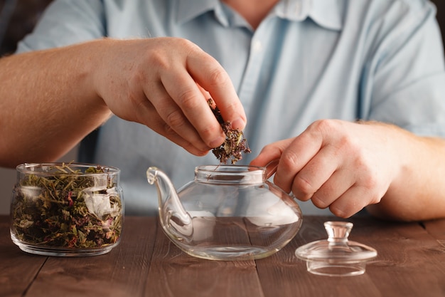 Photo l'homme prépare une tisane dans une bouilloire