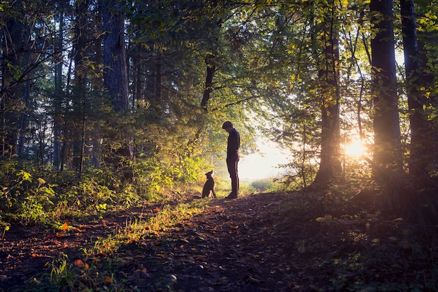 Homme promener son chien dans les bois