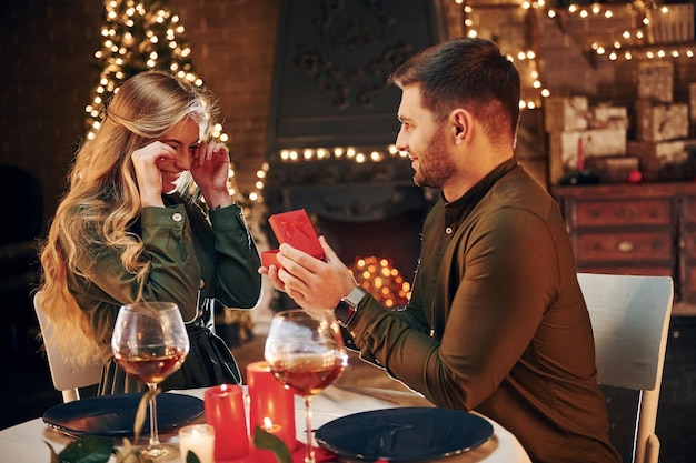 Un homme propose à une belle femme de l'épouser dans un restaurant élégant