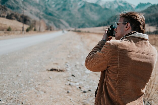 Un homme qui prend des photos dans les montagnes