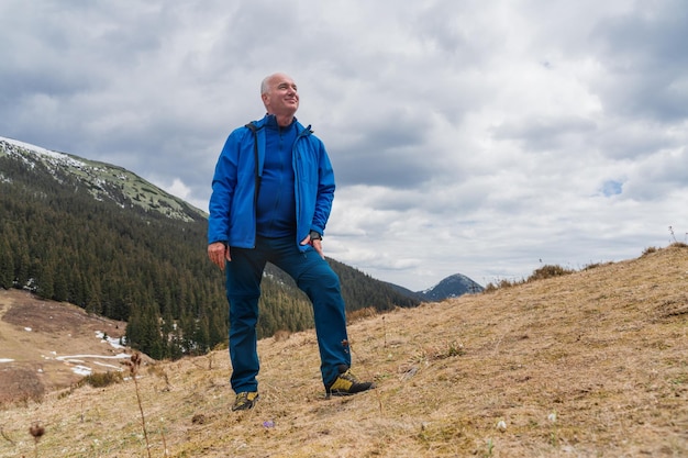 Photo un homme en randonnée apprécie les gouttelettes de neige qui fleurissent dans les montagnes des carpates
