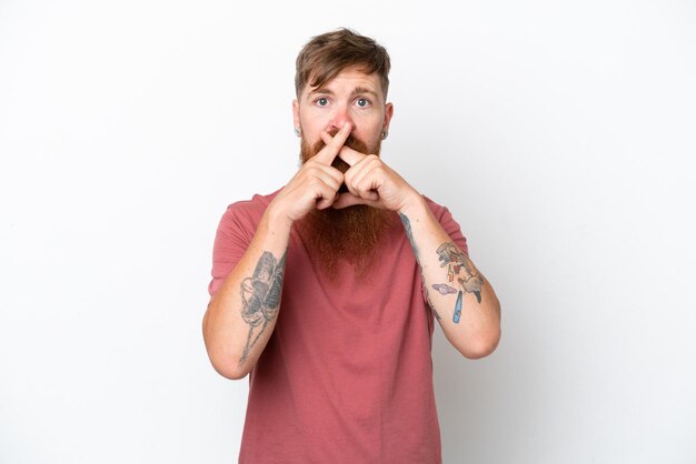 Homme rousse avec une longue barbe isolé sur fond blanc montrant un signe de geste de silence