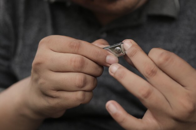 Un homme se coupe les ongles