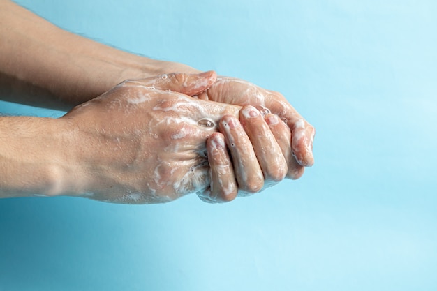 Un homme se lave les mains avec du savon et utilise un antiseptique pour nettoyer et désinfecter ses mains. COVID-2019. Prévention des virus, Coronavirus. Détail de la main concept hygiène.