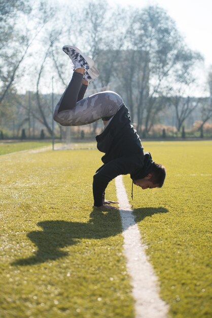 Homme séduisant faisant un stand de la main dans la zone du parc de la ville de formation et d'exercice pour l'Endurance Fitness Concept de mode de vie sain en plein air