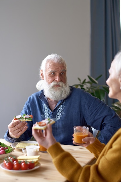 Homme senior parlant à sa femme au déjeuner