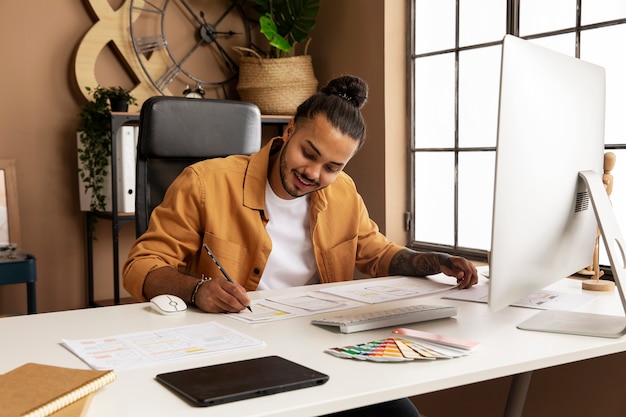 Photo homme souriant à coup moyen travaillant au bureau