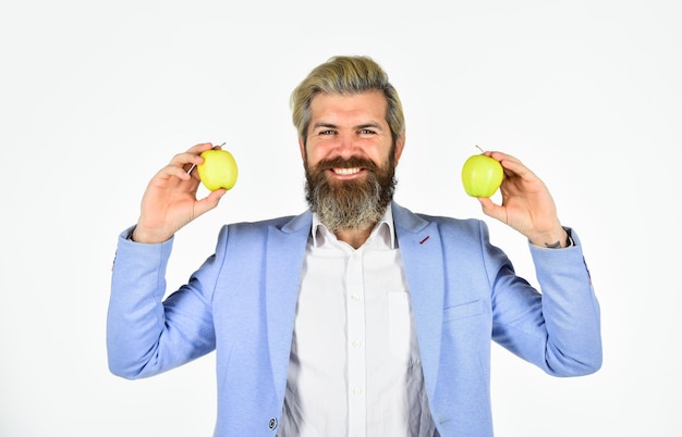 Homme souriant gai avec des pommes. Vitamine et alimentation. Récolte de fruits. Homme d'affaires prospère tenant une pomme. Repas d'affaires. Entreprise d'éducation. Entreprise de récolte. Apple est devenu le symbole de la connaissance.