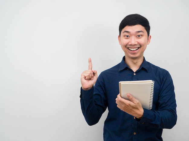 Homme souriant tenant un geste pour ordinateur portable avoir une idée pointer le doigt vers le haut