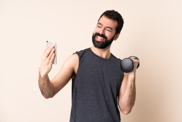 Homme de sport caucasien avec barbe faisant de l'haltérophilie isolé