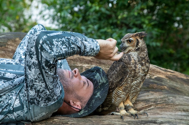 Homme tenant un aigle à poitrine noire