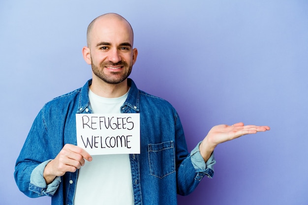 homme tenant une pancarte de bienvenue des réfugiés