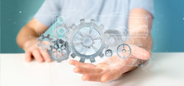 Un homme tenant une roue d'engrenage technologique interface3d rendu