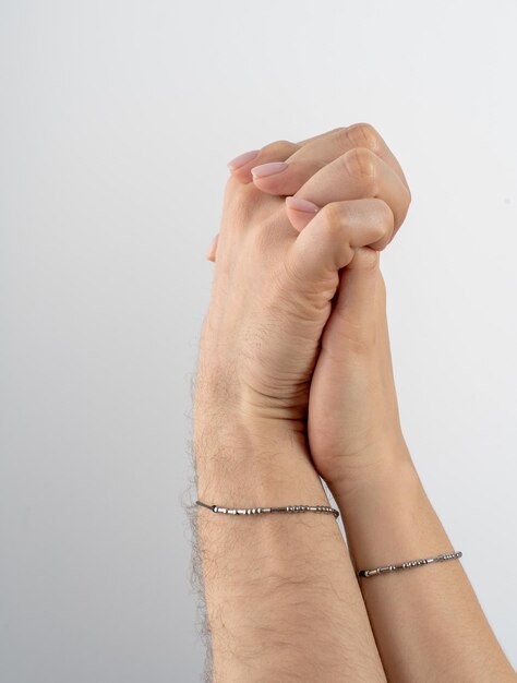 Photo un homme tient la main d'une femme les mains d'un homme et des doigts d'une femmes entrelacés