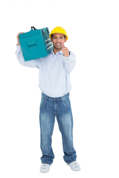 Homme à tout faire dans un casque avec boîte à outils gesticulant pouce en l&#39;air