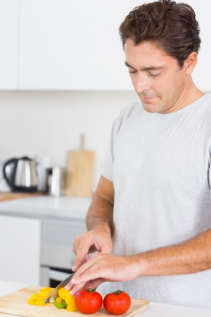 Homme en train de couper des légumes