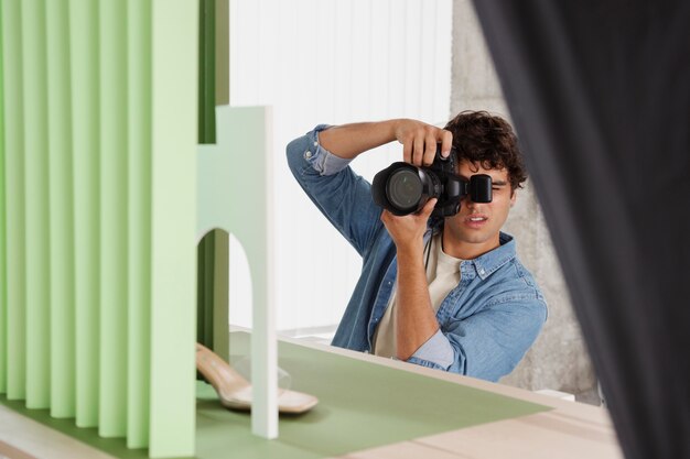 Photo homme travaillant dans son studio de photographie