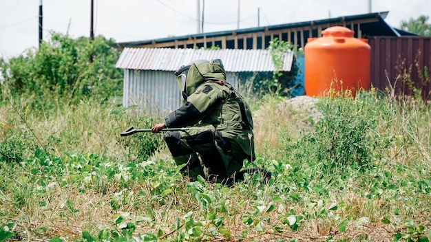 Photo homme en uniforme de démineur faisant son travail